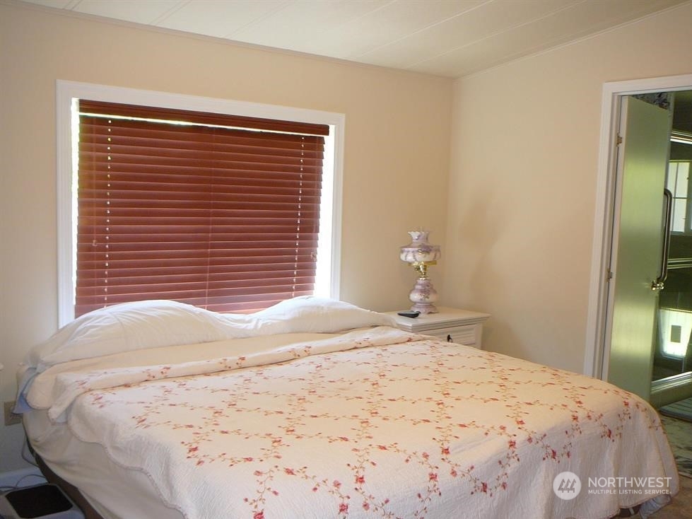 843 Sherburne Road Sequim, WA 98382 - Photo 22 of 40 a bedroom with a bed and a mirror