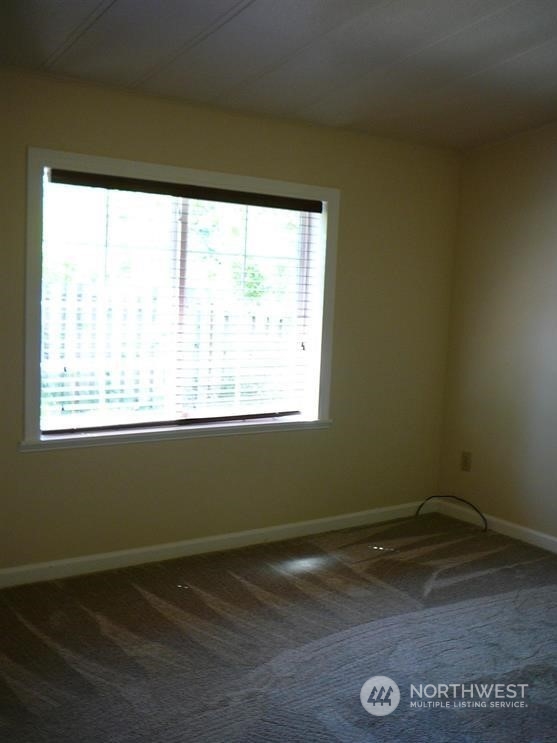 843 Sherburne Road Sequim, WA 98382 - Photo 26 of 40 a view of a room with wooden floor and a window