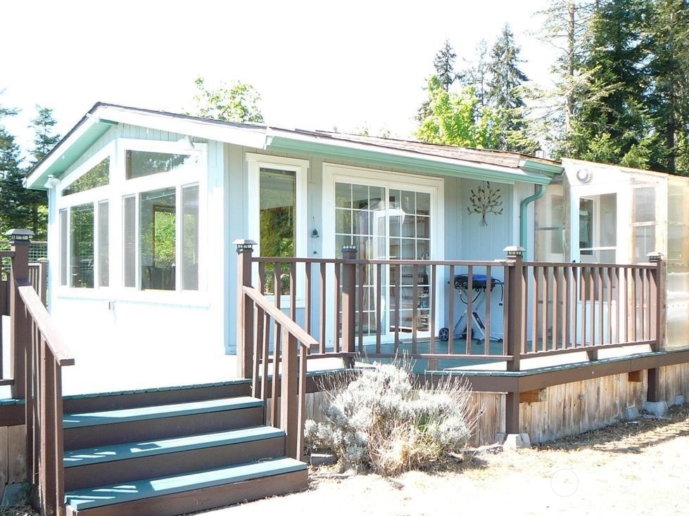 843 Sherburne Road Sequim, WA 98382 - Photo 33 of 40 a view of a house with a small yard and wooden floor and fence