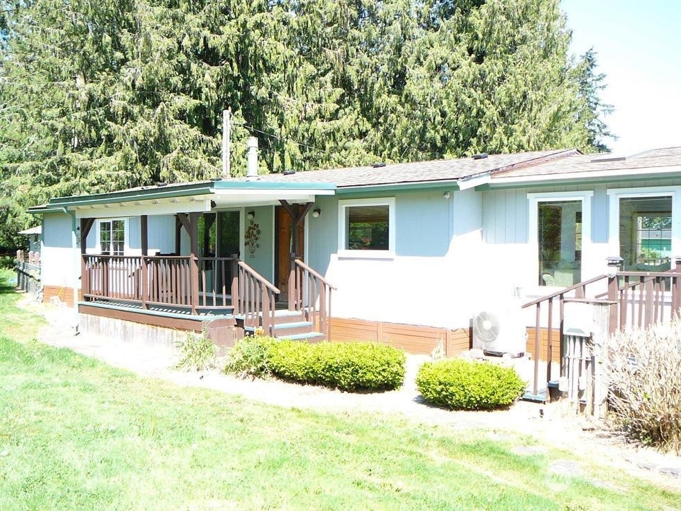 843 Sherburne Road Sequim, WA 98382 - Photo 6 of 40 a view of a house with a patio and a yard