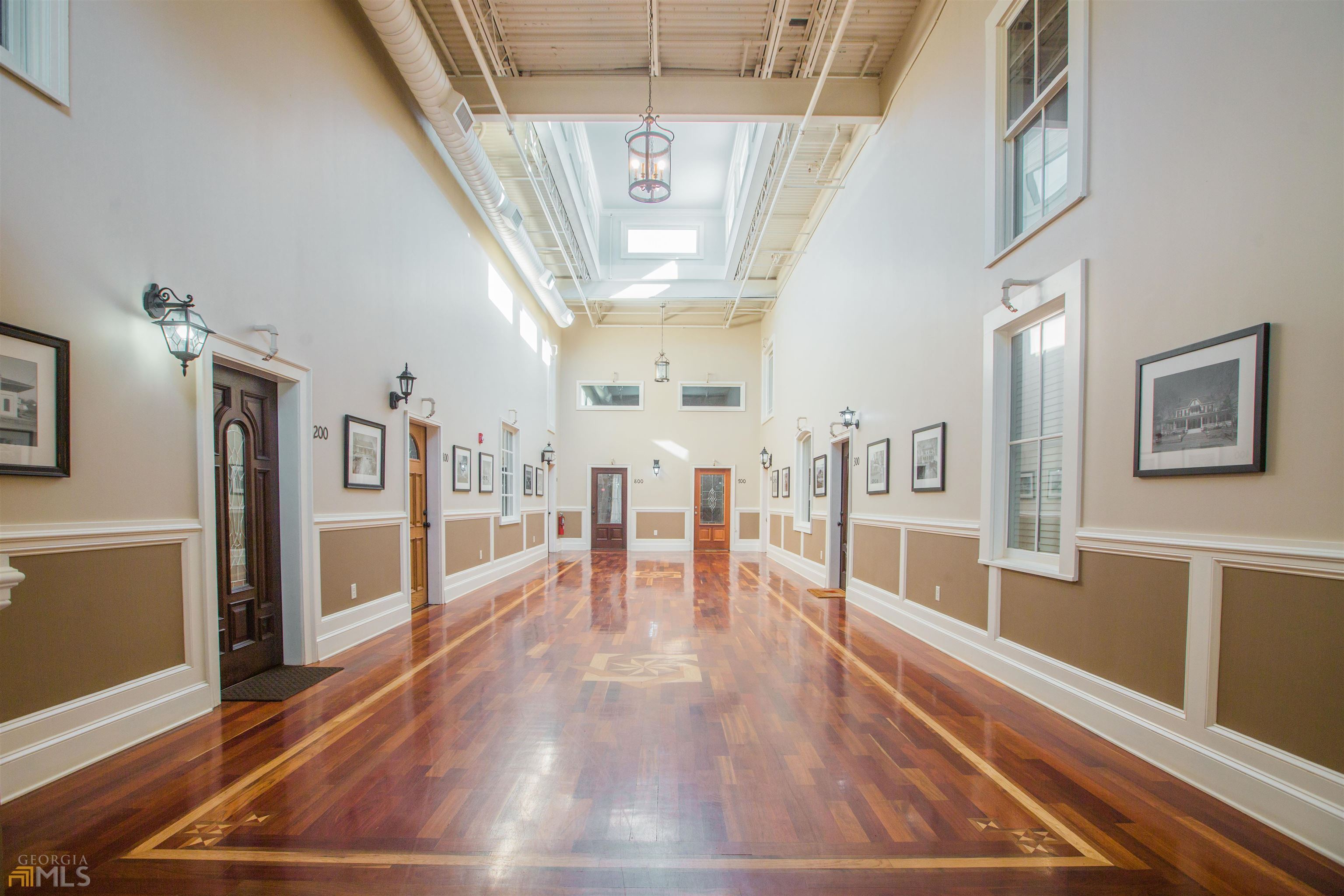a view of a living room and entryway with wooden floor