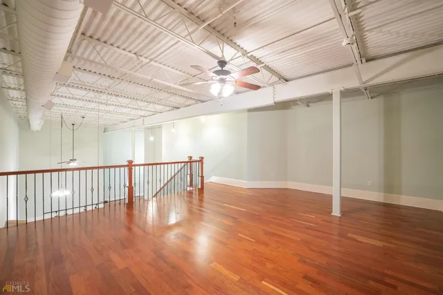 a view of a room with wooden floor