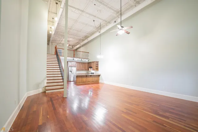 a view of a room with wooden floor and staircase