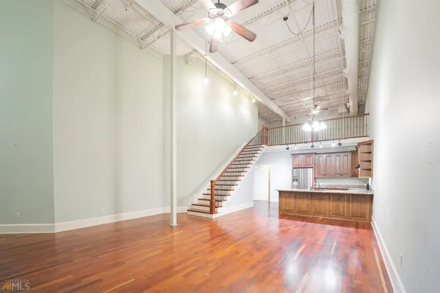 a view of entryway and hall with wooden floor