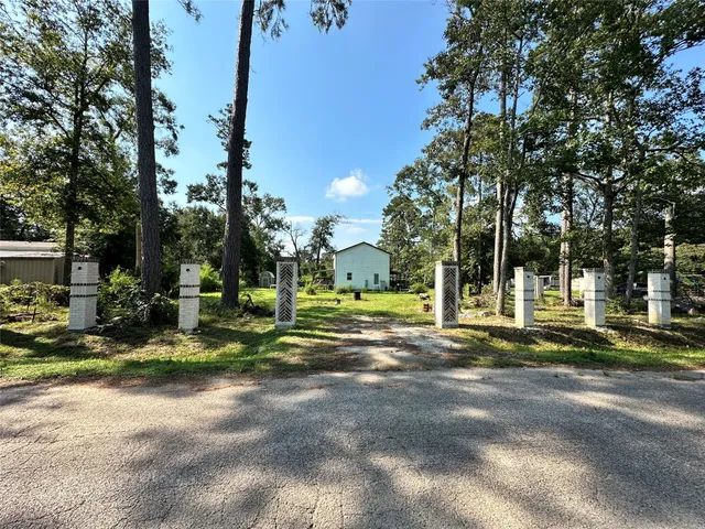 a view of a house with a yard and tree s