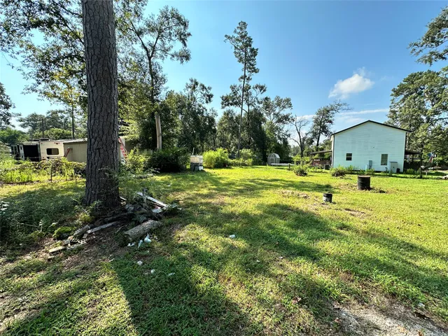 a view of backyard with swimming pool