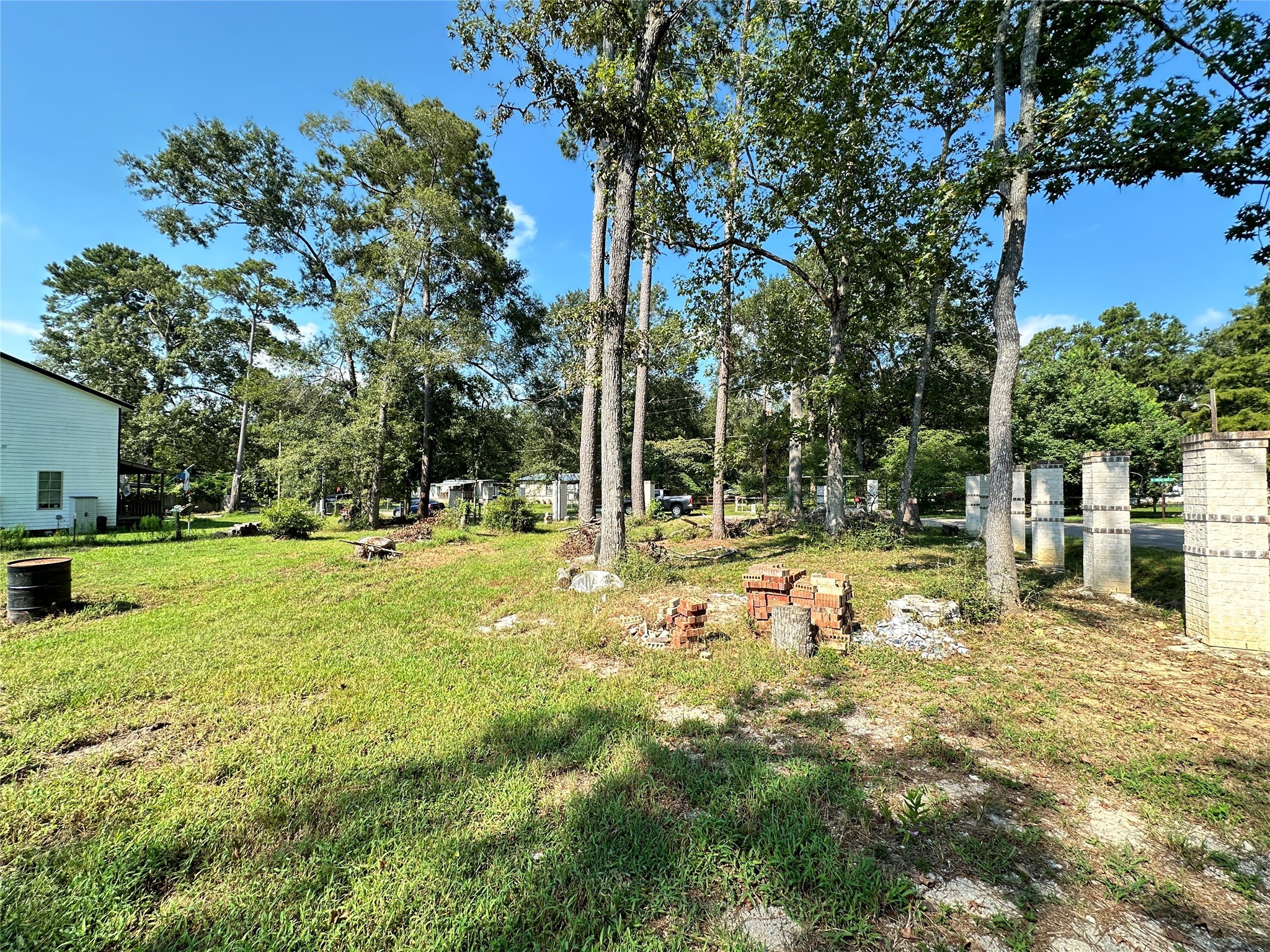 2606 West Twelve Oaks Splendora, TX 77372 - Photo 6 of 7 a view of backyard with a garden and trees