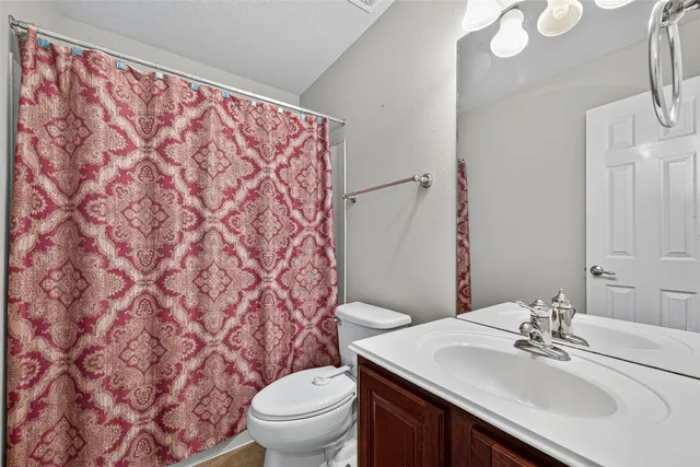a bathroom with a sink toilet and a mirror