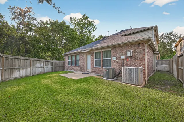 a view of a backyard with a garden and deck