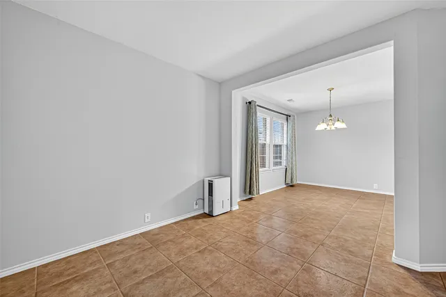 a view of a big room with windows and chandelier fan