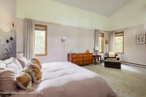 a bedroom with a bed and a couch