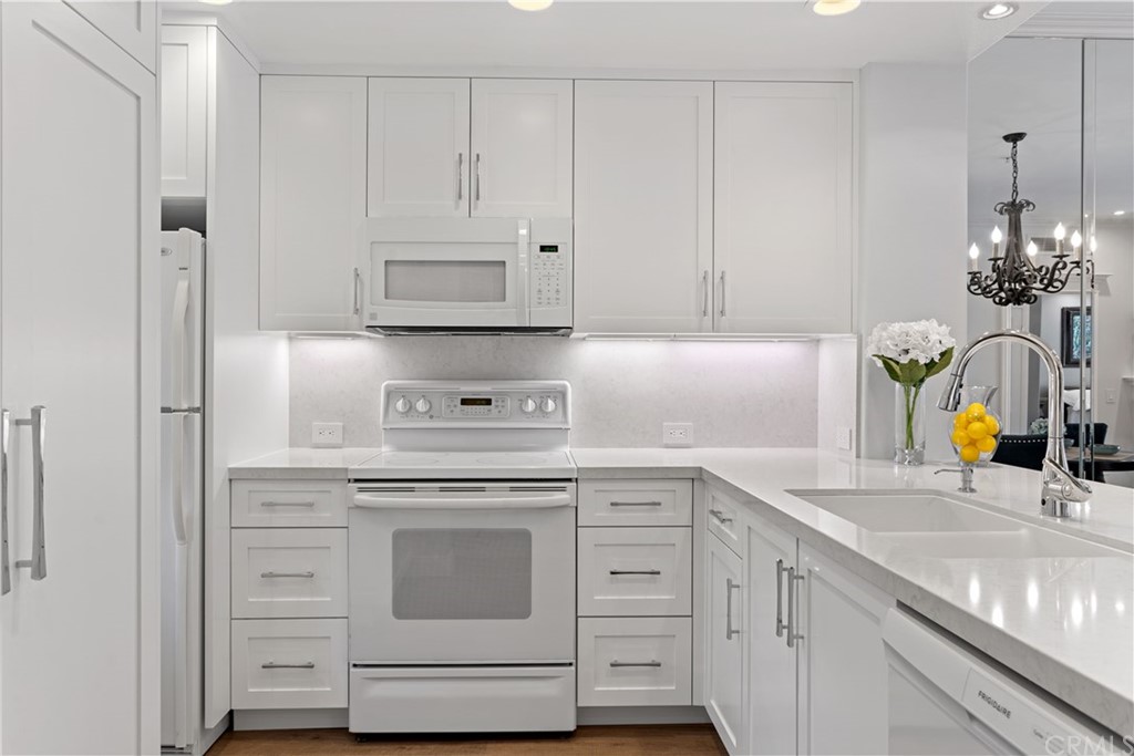 a kitchen with cabinets appliances and a sink