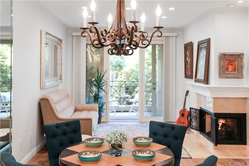 2243 Martin, Unit 314 Irvine, CA 92612 - Photo 12 of 75 a view of a dining room with furniture a chandelier and wooden floor