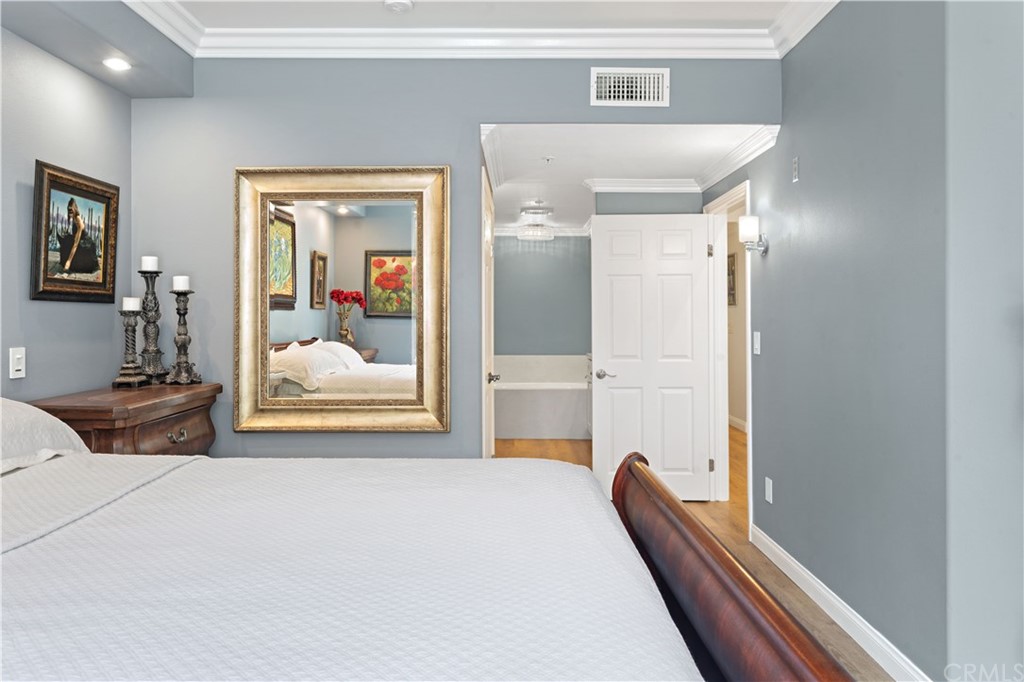 2243 Martin, Unit 314 Irvine, CA 92612 - Photo 35 of 75 a bedroom with a bed and a large mirror