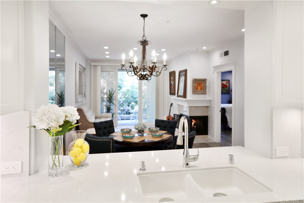 2243 Martin, Unit 314 Irvine, CA 92612 - Photo 4 of 75 a living room with fireplace furniture and a chandelier