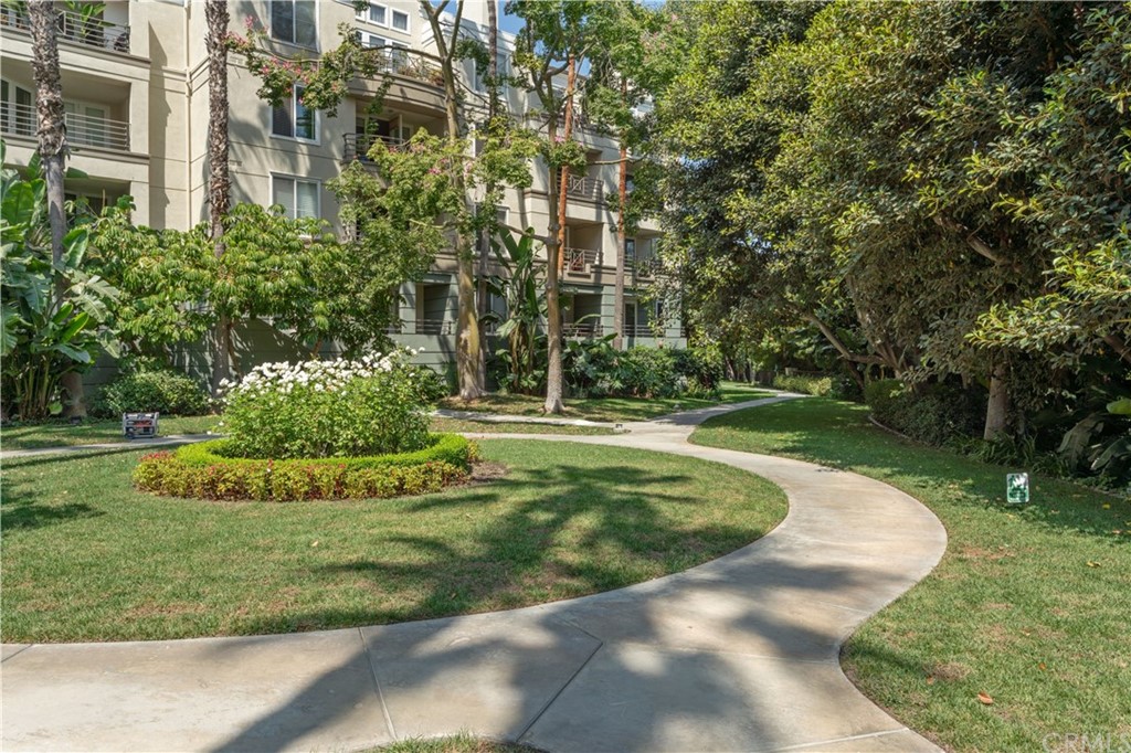 2243 Martin, Unit 314 Irvine, CA 92612 - Photo 59 of 75 a view of a fountain in front of a big yard with plants and large trees