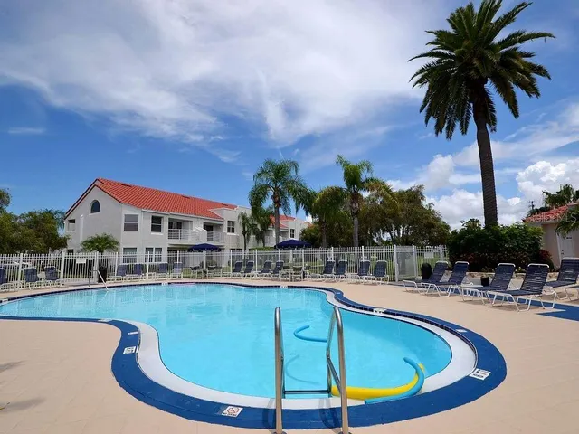 a swimming pool with outdoor seating and yard