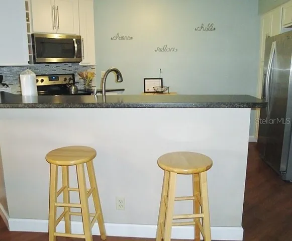 a bathroom with a toilet a sink and a window