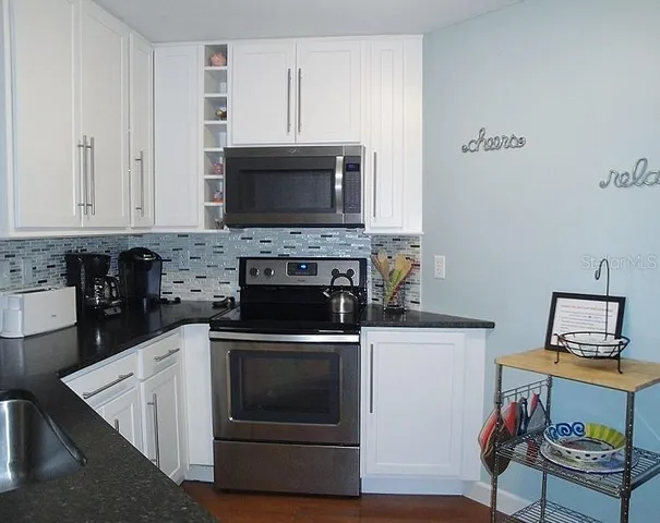 a kitchen with a stove and a microwave