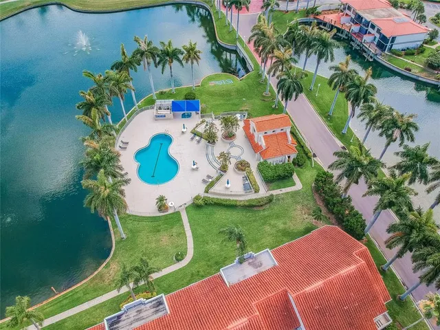 an aerial view of a house with garden space and a swimming pool