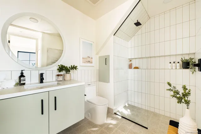 a bathroom with a sink a toilet and a mirror