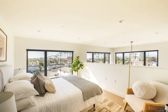 a bedroom with a large bed and a large window