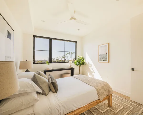 a bedroom with a bed and a large window