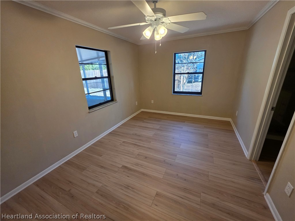 2858 North Lancaster Road Avon Park, FL 33825 - Photo 10 of 13 wooden floor in an empty room with a window