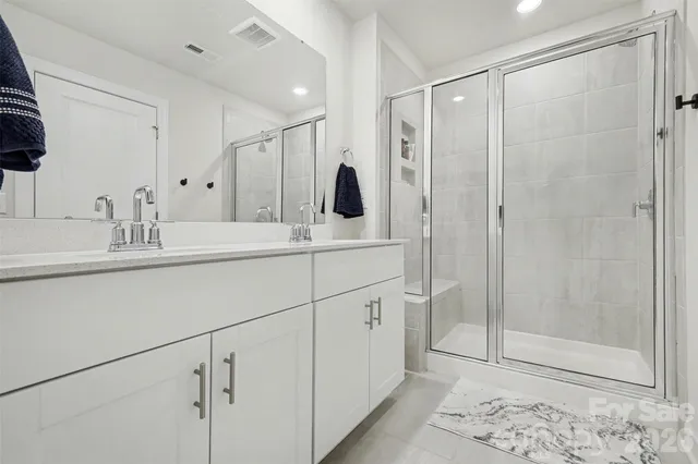 a living room with furniture a window and a potted plant
