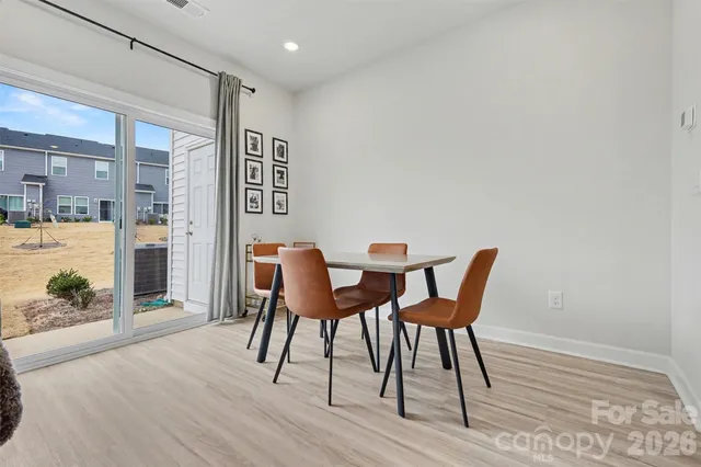 a dining room with furniture and wooden floor