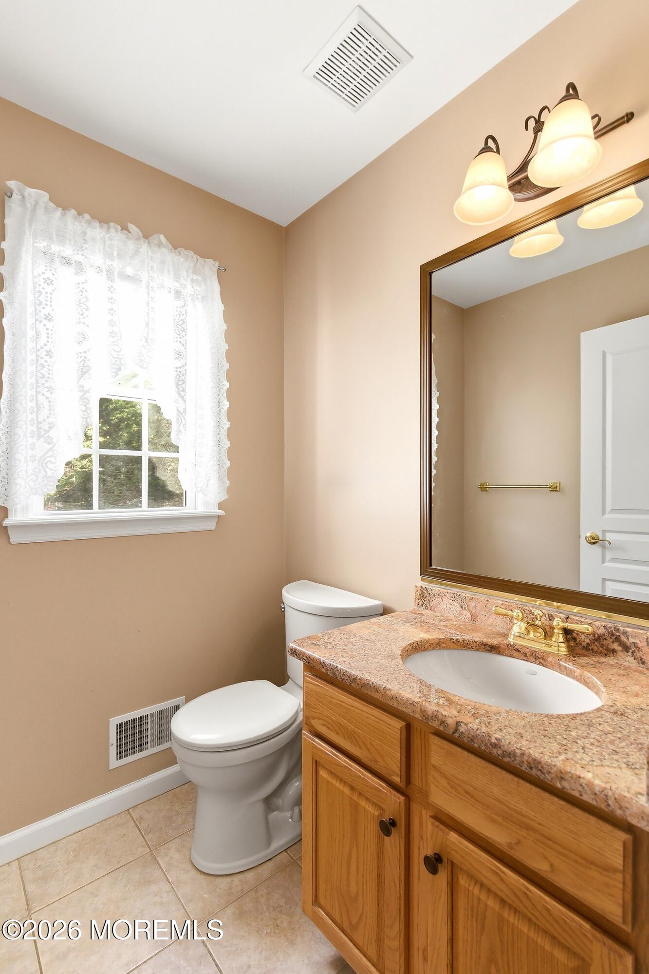 1677 Joffre Road Forked River, NJ 08731 - Photo 14 of 35 a bathroom with a granite countertop toilet sink and mirror