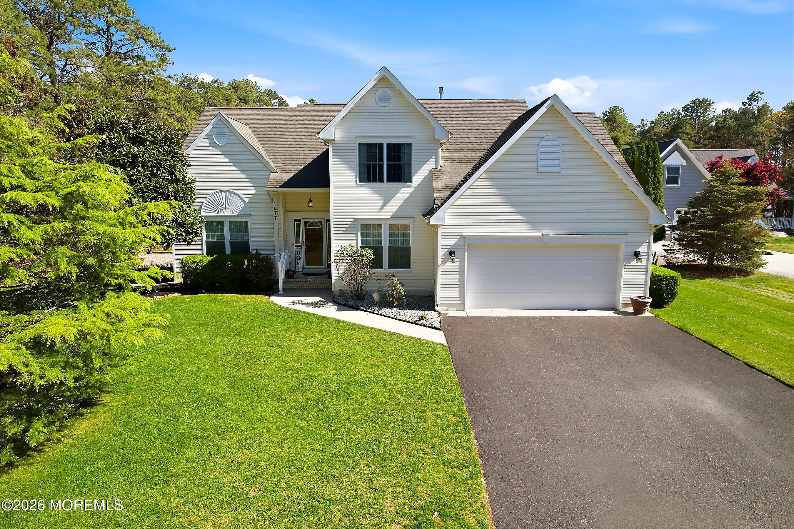 1677 Joffre Road Forked River, NJ 08731 - Photo 3 of 35 a front view of a house with a garden and yard