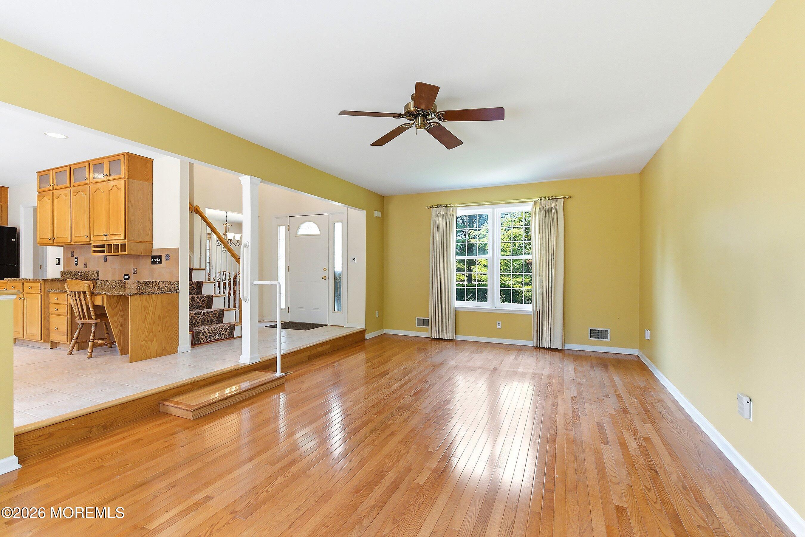 1677 Joffre Road Forked River, NJ 08731 - Photo 7 of 35 a view of empty room with wooden floor and fan