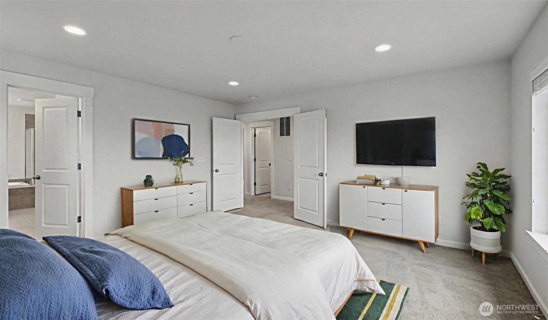 20024 90th Place South Kent, WA 98031 - Photo 16 of 28 a bedroom with a bed and a flat tv screen on dresser