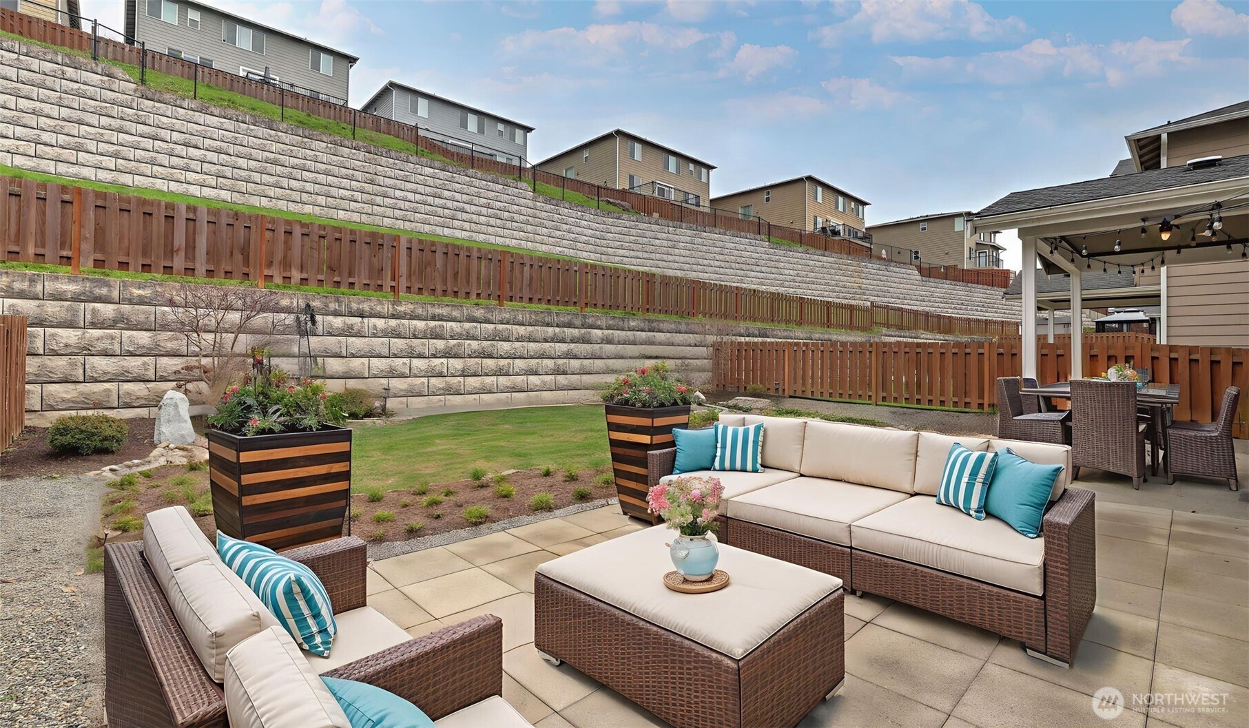 20024 90th Place South Kent, WA 98031 - Photo 26 of 28 a view of a patio with couches table and chairs and potted plants