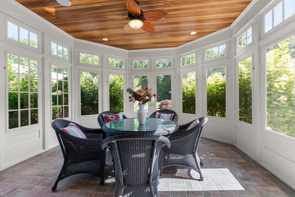 66 Goodnow Road Sudbury, MA 01776 - Photo 18 of 42 a dining room with furniture large windows and wooden floor