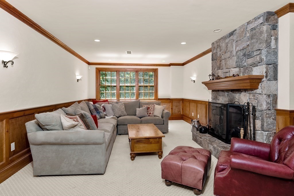 66 Goodnow Road Sudbury, MA 01776 - Photo 27 of 42 a living room with furniture and a fireplace