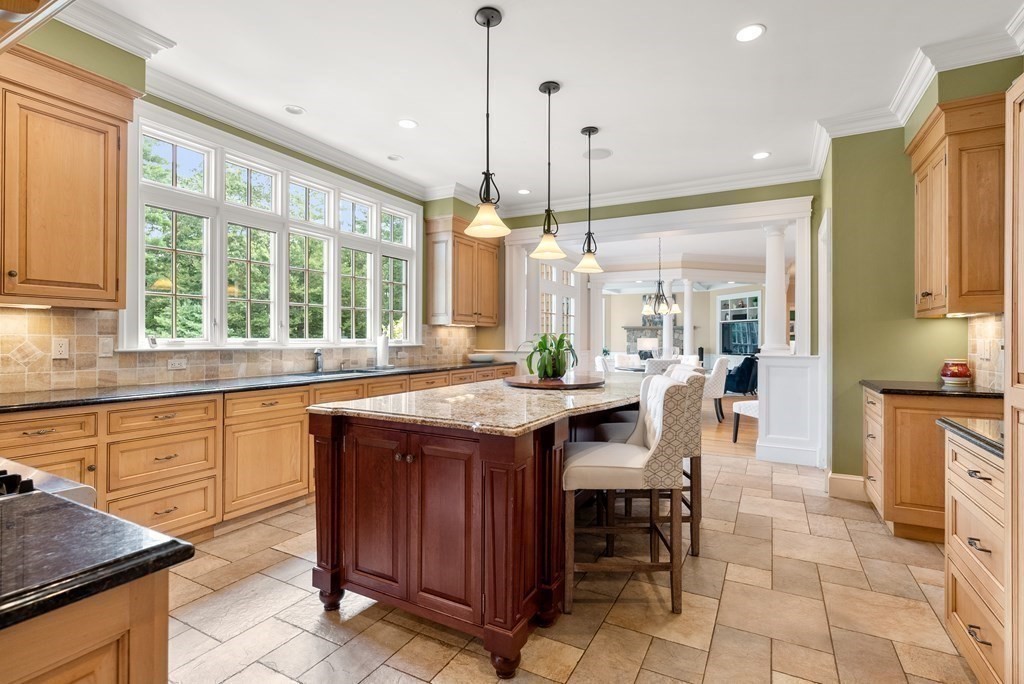 66 Goodnow Road Sudbury, MA 01776 - Photo 10 of 42 a kitchen with stainless steel appliances granite countertop wooden cabinets a stove a sink and a large window