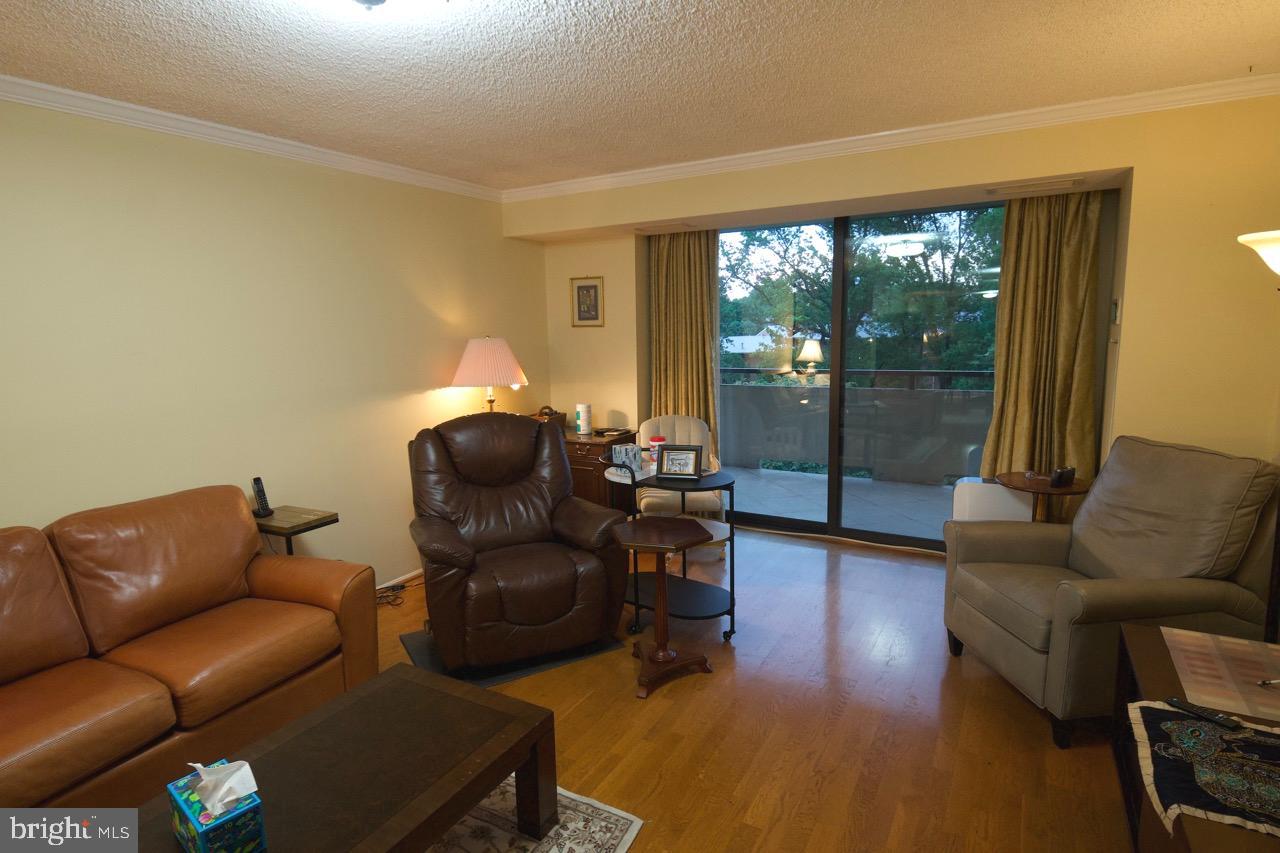 1800 Old Meadow Road, Unit 818 McLean, VA 22102 - Photo 4 of 35 a living room with furniture and a large window