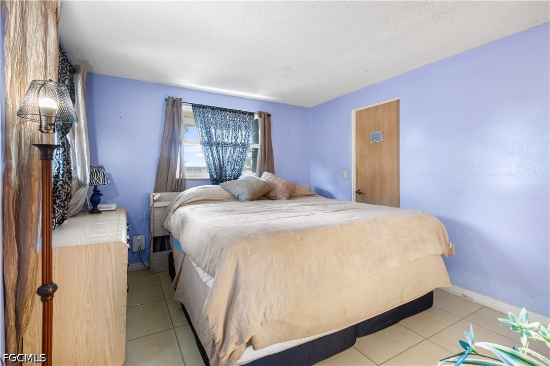 18 Illinois Road Lehigh Acres, FL 33936 - Photo 26 of 45 a bedroom with a bed and window