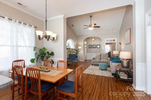 a view of a a dining room with furniture window and wooden floor