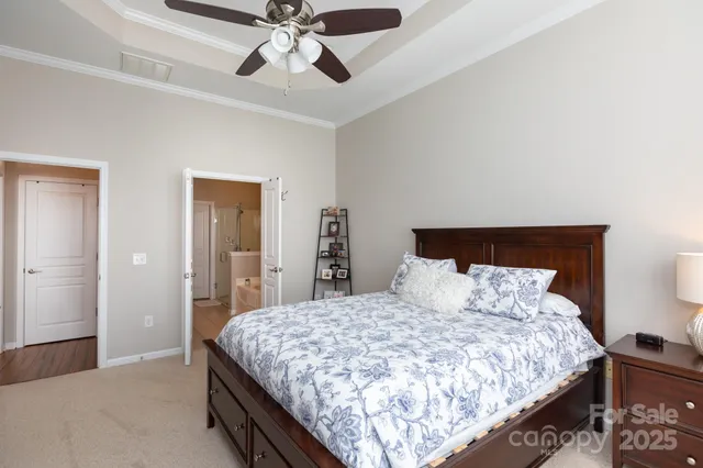 a bedroom with a bed and ceiling fan