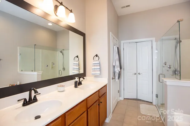 a bathroom with a double vanity sink mirror and double