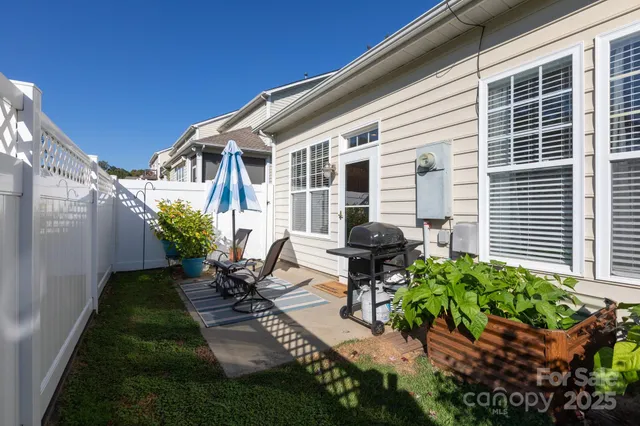 a view of a patio with table and chairs and potted plants