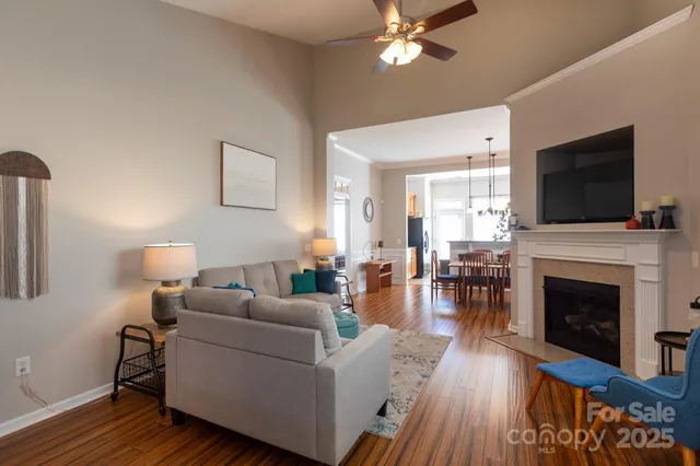 a living room with furniture a fireplace and a flat screen tv