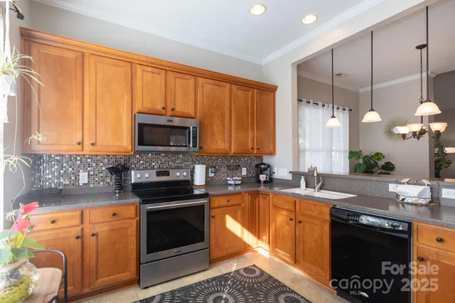 a kitchen with a sink stove and microwave