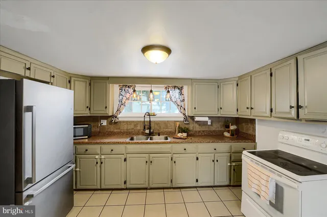 a kitchen with a sink window and cabinets