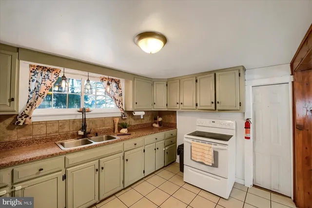 a kitchen with a sink cabinets and window