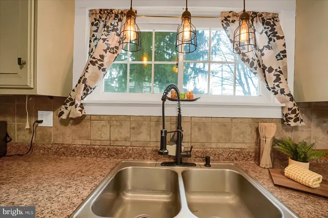 a kitchen with a sink and a window
