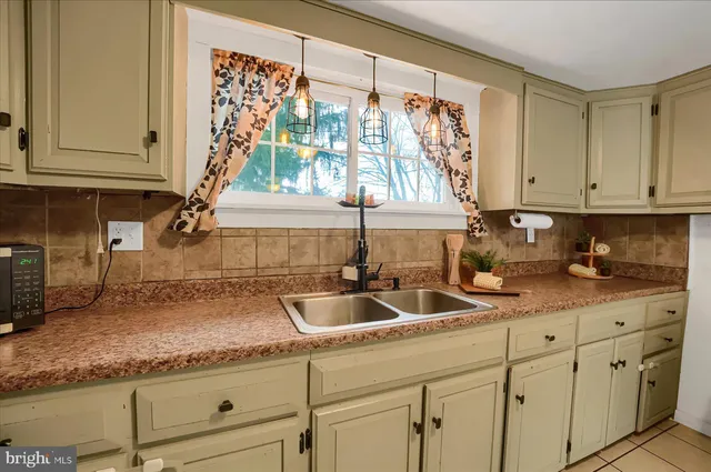 a kitchen with granite countertop a sink and a window